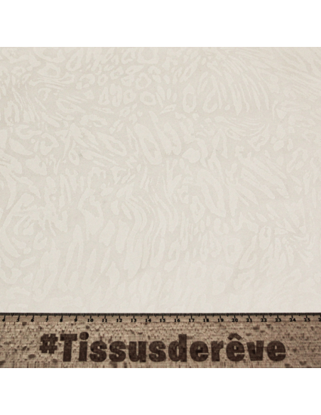 Gabardine floquée coton & élasthanne – Motif animalier blanc ton sur ton