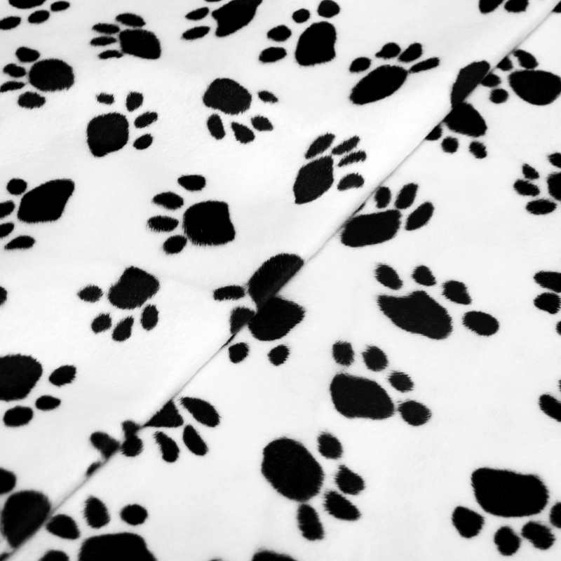 Fourrure synthétique - Pattes de chien noir sur fond blanc