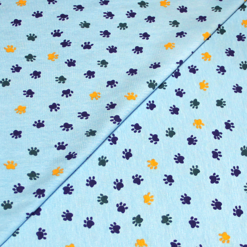 Jersey coton & élasthanne - Patte de chien multicolore fond bleu