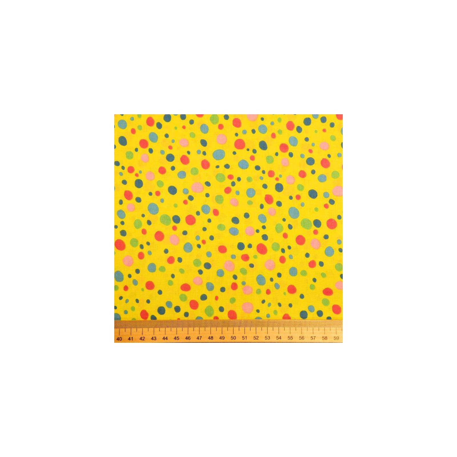 Coton imprimé pois multicolores sur fond jaune