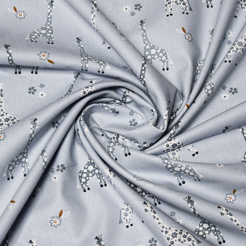 Popeline 100% coton - Motif girafe fond bleu charrette