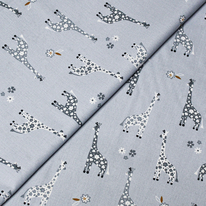 Popeline 100% coton - Motif girafe fond bleu charrette
